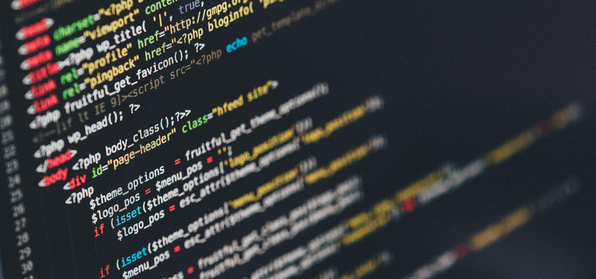 A picture of a laptop screen showing lines of full code